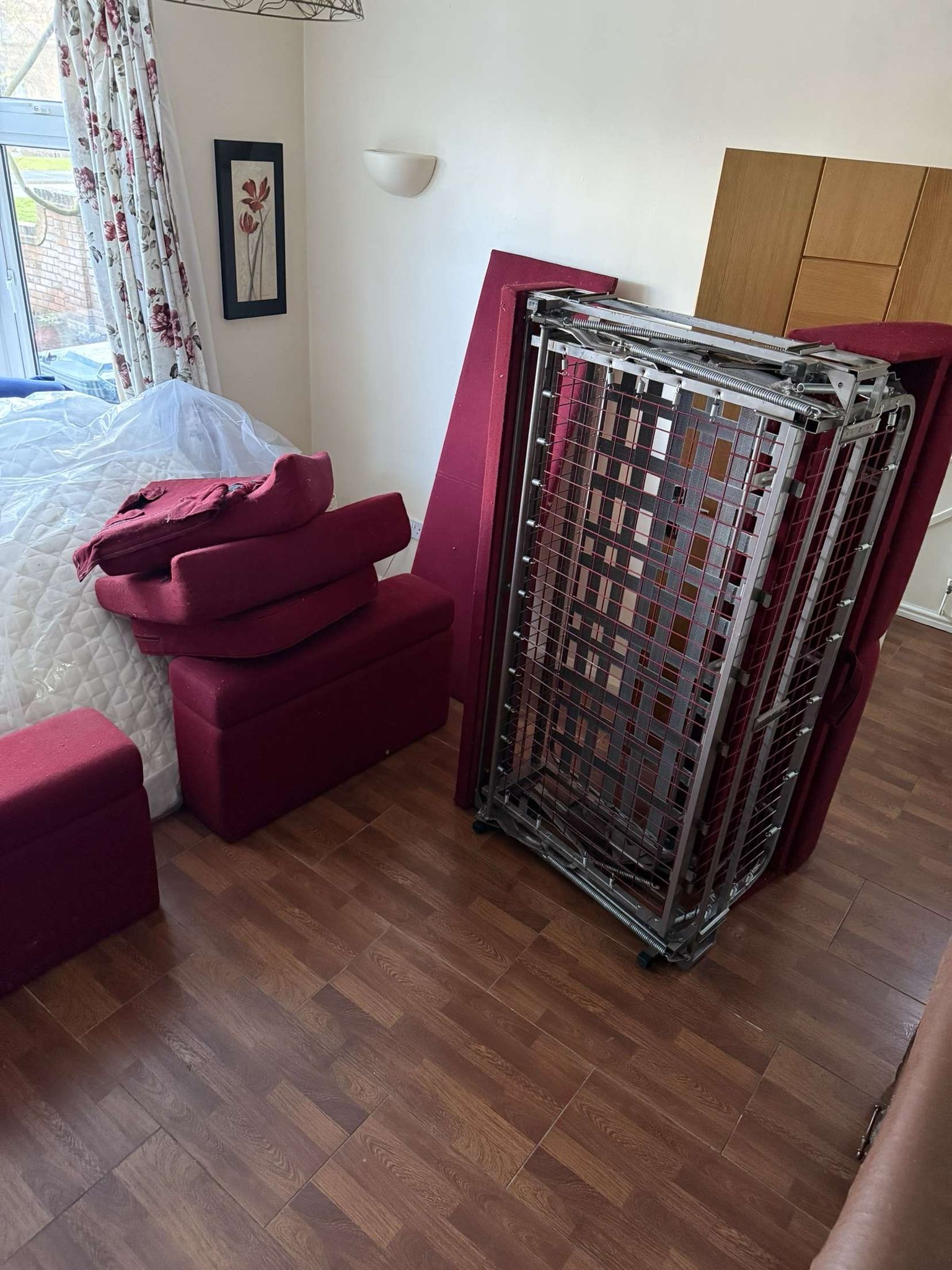 red sofa dismantled ready for removal